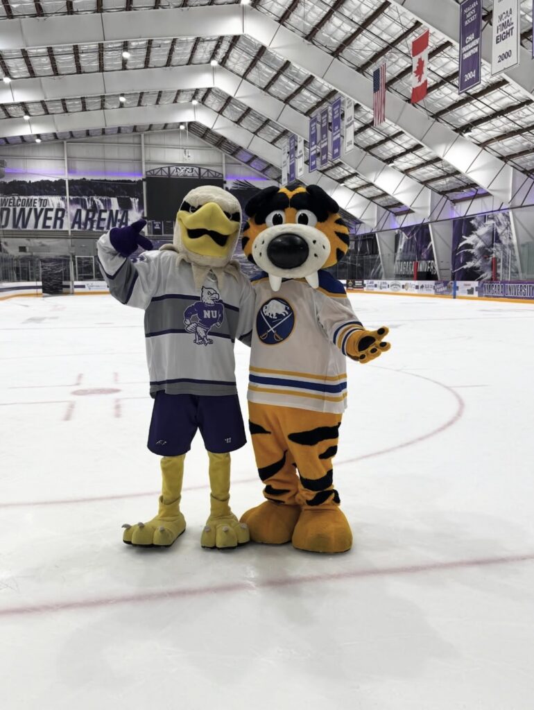 Monte and Sabre Tooth standing on the ice in the Dwyer Arena